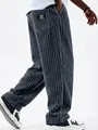 Detailed view of men's wide-ribbed corduroy pants showing the fabric texture and logo patch - Navy Blue