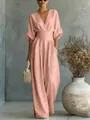 Detailed view of an elegant pink V-neck jumpsuit featuring a cinched waist and wide legs. - Pink