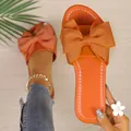 Sandalias planas naranja vibrante con un lazo grande para la playa y el uso diario - Naranja