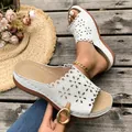 White floral laser-cut platform wedge sandals shown in a summer beach boardwalk setting - 38 / White