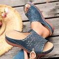 Close-up detail of blue laser-cut floral wedge sandals with platform soles for summer - 38 / Dark Blue