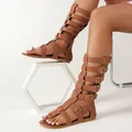 Stylish tan high-top gladiator sandals with multiple buckle straps and a flat sole. - 38 / Flat Gladiator Boots / Tan