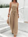 Stylish wide-leg sleeveless jumpsuit with waist knot detail shown on model outdoors. - S / Dresses / Apricot