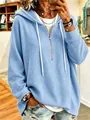 Detailed view of a blue waffle knit hooded sweatshirt with a quarter zipper closure. - S / Tops / Blue