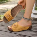 Stylish women's yellow wedge sandals with large flower decoration on outdoor wooden deck - 38 / Yellow