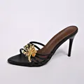 Elegant black stiletto mule sandals featuring a large decorative gold metallic flower. - 35 / Black Flower