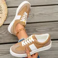 Detail shot of tan suede sneakers with white stripes on wooden background - 36 / Khaki