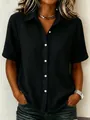 Close-up of a stylish black cotton button-down shirt with a crinkled fabric texture. - 3XL / Tops / Black