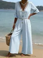 Macro detail of a light blue V-neck jumpsuit featuring white lace trim on a beach - XL / Blue