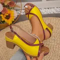 Detailed view of yellow and burgundy color-block chunky heel sandals with buckle strap - Yellow