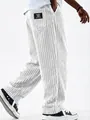Detailed view of white corduroy ribbed pants with classic wear logo patch on back pocket - White