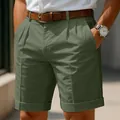 Detail of olive green men's pleated shorts with cuffed hem for business casual look - S / Bottoms / Green