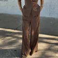 Detail shot of elegant brown short-sleeve blazer and high-waist wide-leg trouser set - S / Bottoms