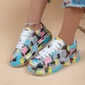 Detailed view of women's colorful graffiti print platform sneakers with white laces. - 35 / Gray