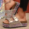 Detail view of sparkly rhinestone platform slides with colorful beads and double buckles - 38 / Gold