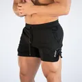 Close-up of men's quick-dry black sports shorts for running and fitness training. - M / Bottoms / Black