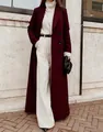 Stylish long burgundy wool coat for women shown in an elegant outdoor winter street setting - Burgundy