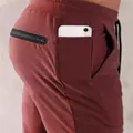 Close-up of side phone pocket and zipper back pocket on men's burgundy joggers - M / Bottoms / Burgundy