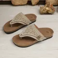 Detailed view of beige wedge flip-flops featuring laser-cut patterns and metal studs. - 38 / Khaki