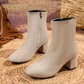 Close-up detail of beige suede-like ankle boots with a side zipper and a comfortable block heel - 38 / Beige Faux Suede