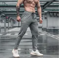 Athletic men's quick-dry fitness joggers in grey showing slim fit and elastic waist. - S / Bottoms / Light Gray