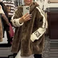 Detail view of fashion loose brown plush hooded jacket with white striped sleeve design - Brown White