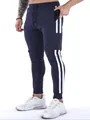 Detail view of navy blue cargo joggers with white stripes and functional side pockets - S / Bottoms / Navy Blue