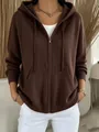 Close-up view of a stylish brown knitted zip-up hoodie featuring a hood and front pockets - Coffee