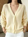 Detailed view of a light yellow mesh knit cardigan with V-neck and button closure - S / Tops / Yellow