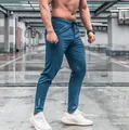 Detailed view of lightweight blue mens slim fit quick dry sports training pants - S / Bottoms / Lake Blue