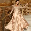 Detailed view of champagne V-neck evening gown with sequined stripes and satin skirt - Gold