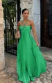 Elegant green halter neck pleated maxi dress with waist cutout design worn by a model - S / Dresses / Light Green