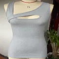 Close-up of a grey ribbed sleeveless tank top featuring an asymmetrical cutout design - Gray