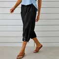 Detailed view of women's black linen capri pants with drawstring and button hem - S / Bottoms / Black