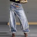 Detailed view of women's light blue deconstructed jeans with heavy rhinestone embellishments - S / Bottoms / Light Blue