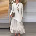 Close-up detail of white asymmetrical knit top and pleated skirt two-piece set for women - S / Top And Bottom / White