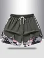 Detail of women's 2-in-1 sports shorts with pink camouflage lining and white drawstring - Army Green
