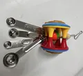 Parrot chewing toy with four stainless steel measuring spoons and a colorful bell ball - Spoon Style