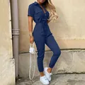 Detail view of a navy blue women's high-waisted tie jumpsuit with buttons and short sleeves. - L / Set / Blue