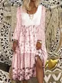 Detailed close-up of a bohemian floral print long sleeve maxi dress with tiered skirt - S / Dresses / Pink