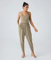 Detailed shot of women's khaki casual jumpsuit featuring a drop crotch and side pockets - S / Apricot