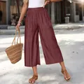 Detailed view of maroon high-waist wide-leg cropped pants with side pockets. - Red