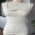 Detailed view of white ribbed sleeveless tank top featuring a sexy front cutout design - Off White