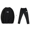 Detailed view of the black sweatshirt and sweatpants tracksuit set with logo print. - M / Top And Bottom / Black