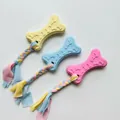 Bone-shaped TPR dog chew toy with braided cotton rope in yellow blue and pink colors - Paw Cookie with Cloth Strip / One Size