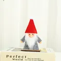 Handmade Christmas gnome figurine with red felt hat and white beard sitting on a book - Grey Clothes Red Hat (V2-27)