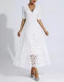 Detailed macro view of the intricate floral lace embroidery on a white V-neck midi dress - S / Dresses / White