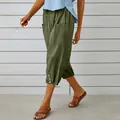 Detail view of olive green cotton linen cropped joggers with side buttons and drawstring waist. - Army Green