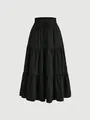 Detailed view of black tiered cake skirt with elastic drawstring waist and textured fabric - S / Bottoms / Black