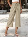 Detail view of women's khaki loose cropped pants with drawstring waist and decorative buttons. - S / Bottoms / Apricot